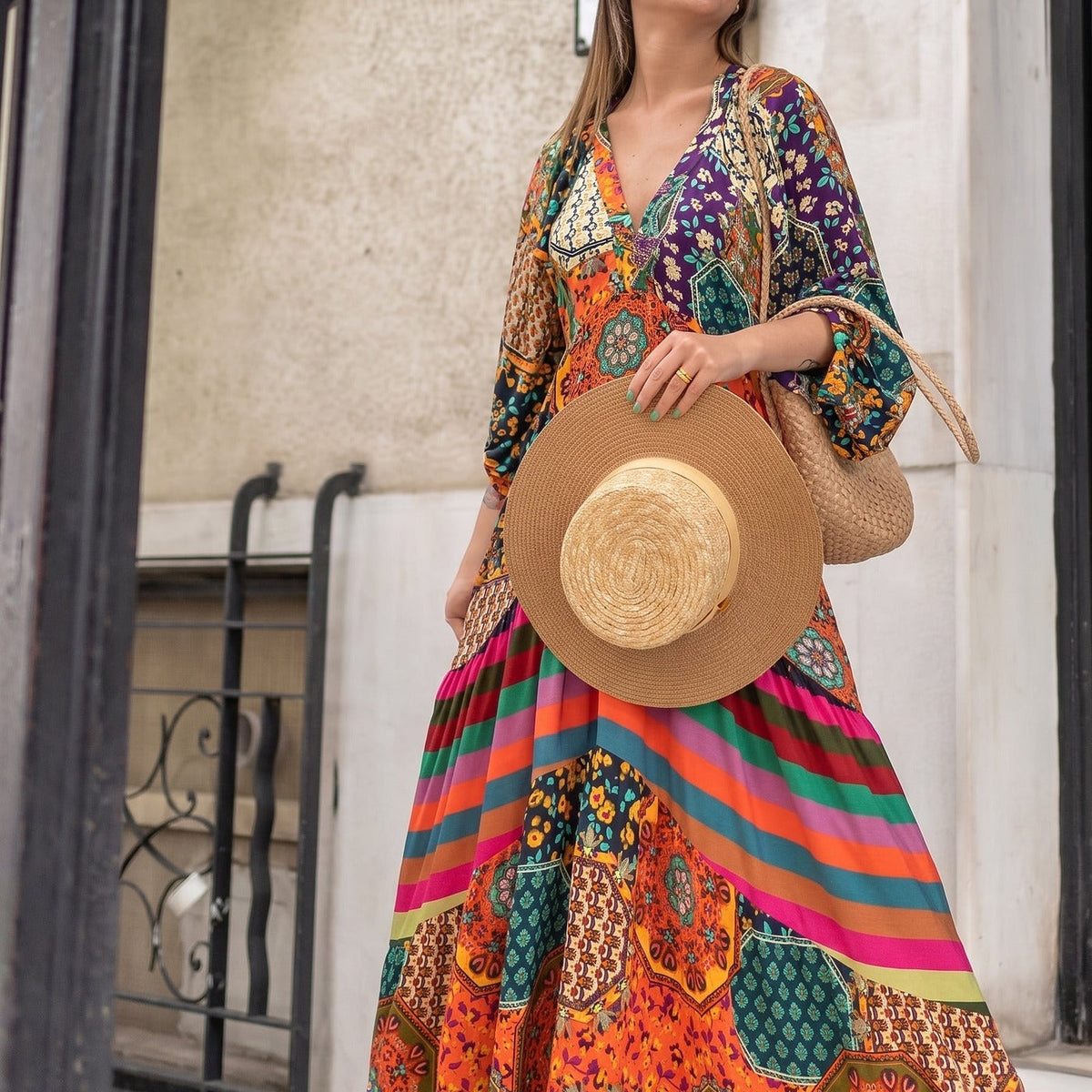 Patchwork maxi dress worn loose with its striped skirt