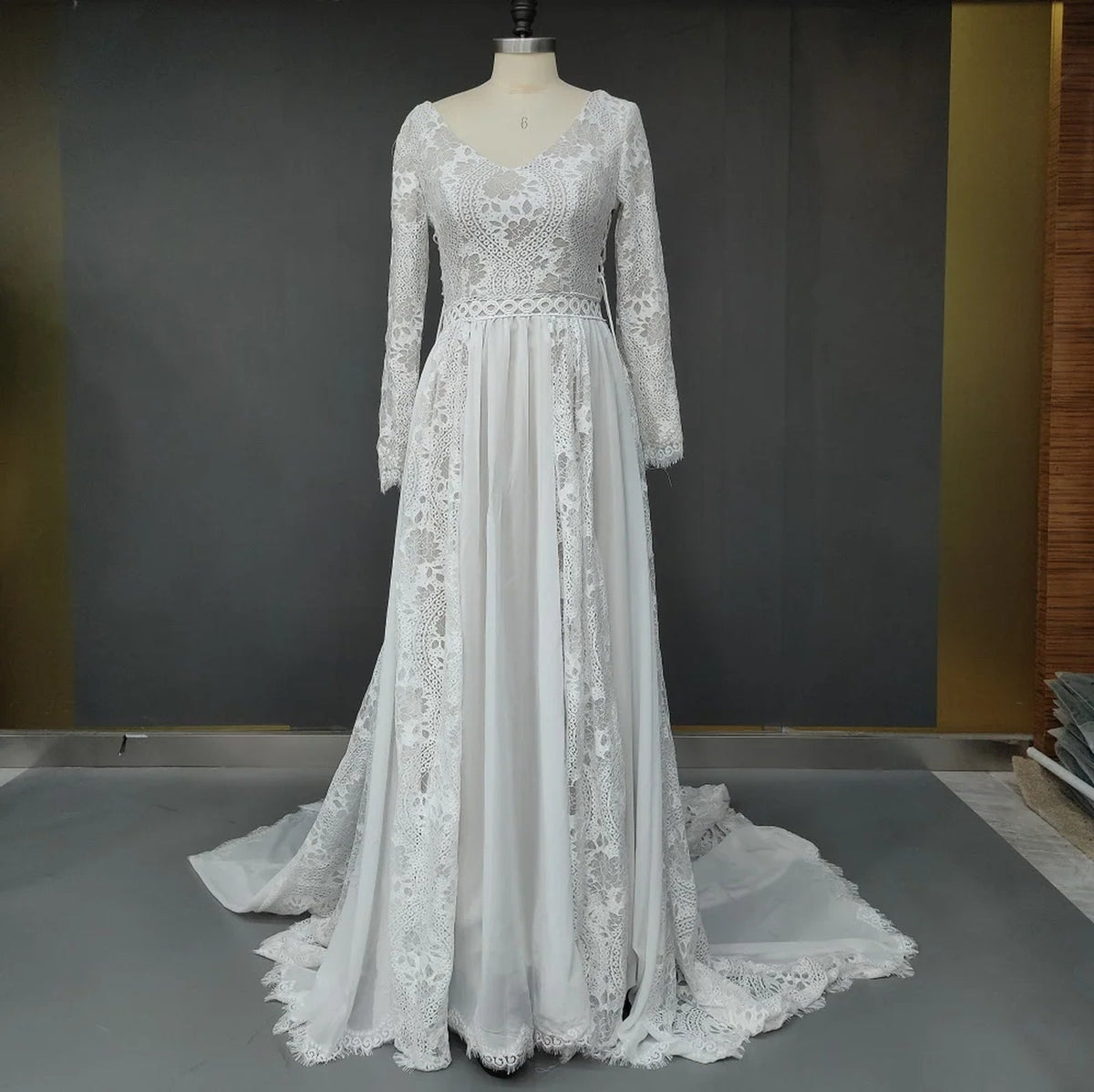 Boho wedding dress on a mannequin with openwork band at the waist