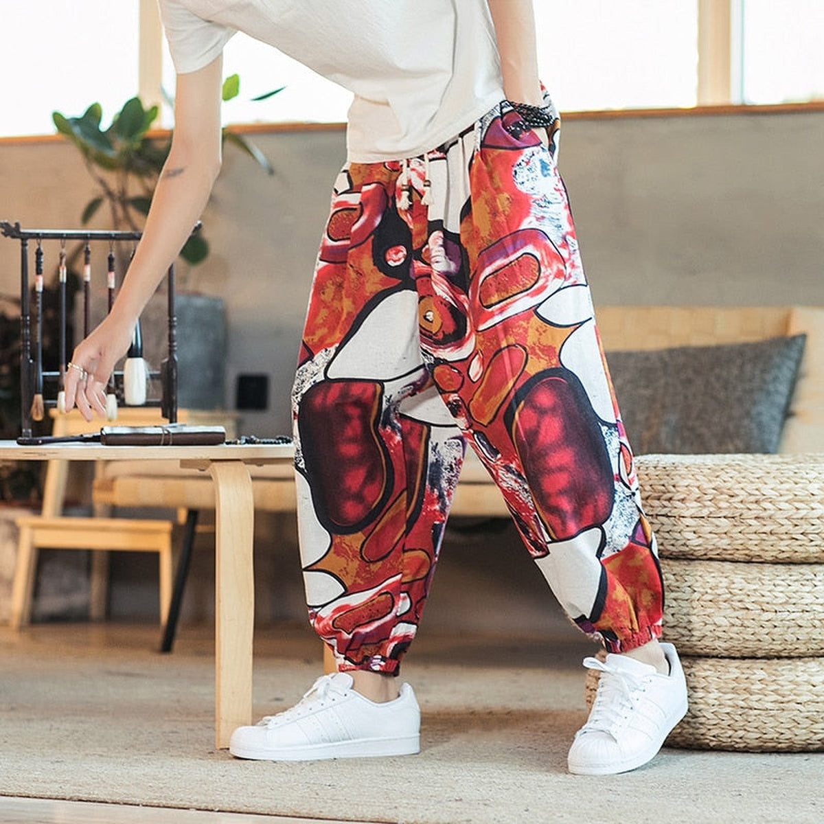 Red colorway of the men's pants with abstract print worn