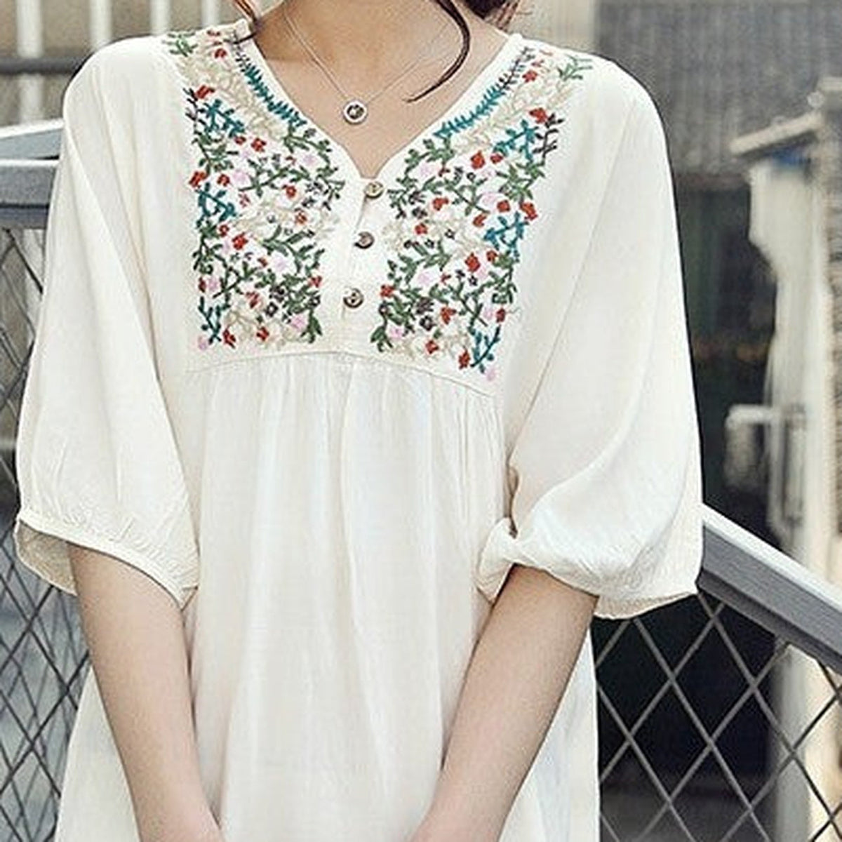 Close-up of the multicolor floral embroidery on the yoke