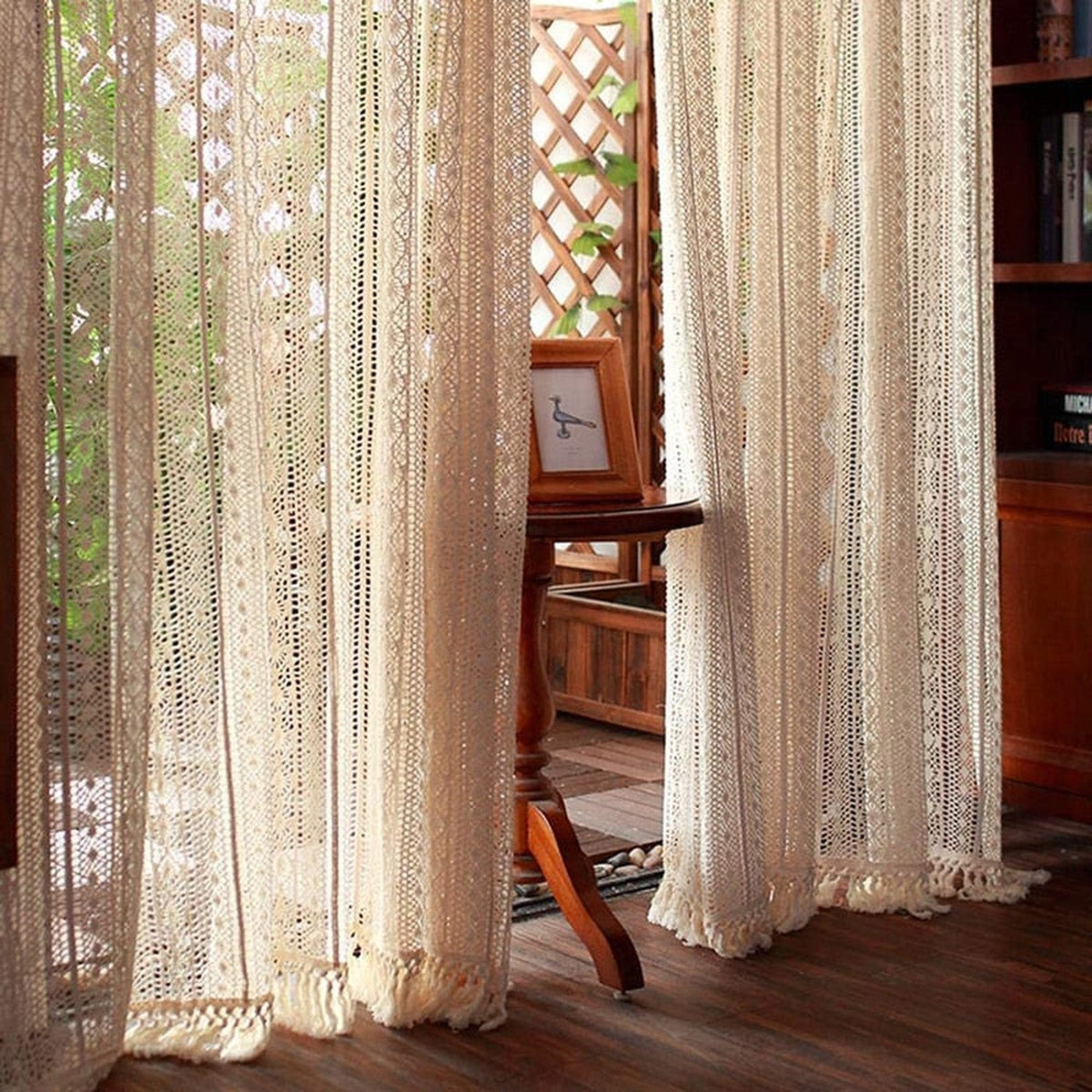 Crochet boho curtain hanging in a wood-paneled interior